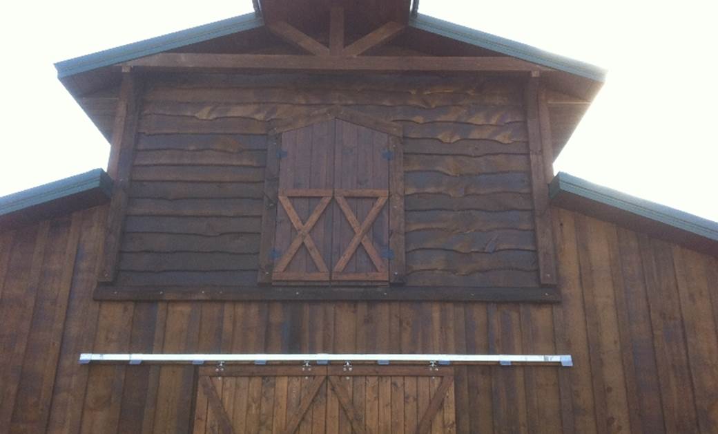 Barn loft with dark wavy edge bevel siding.