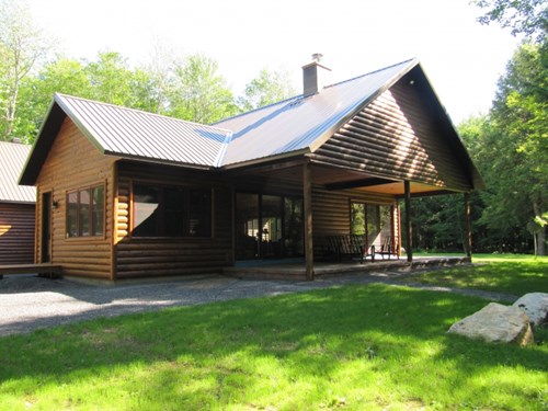 2x8 cedar log siding pre-stained chestnut. 3x4 cedar D-trim and vertical corners. Cedarwood benefits