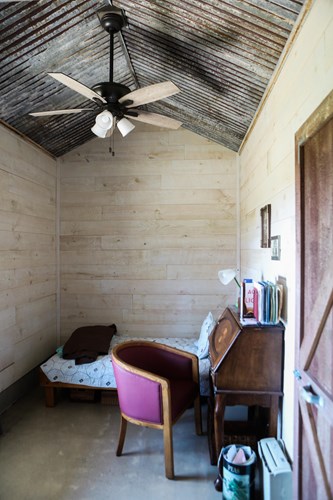 Circle-sawn whitewash shiplap and ranch rusted steel ceiling.