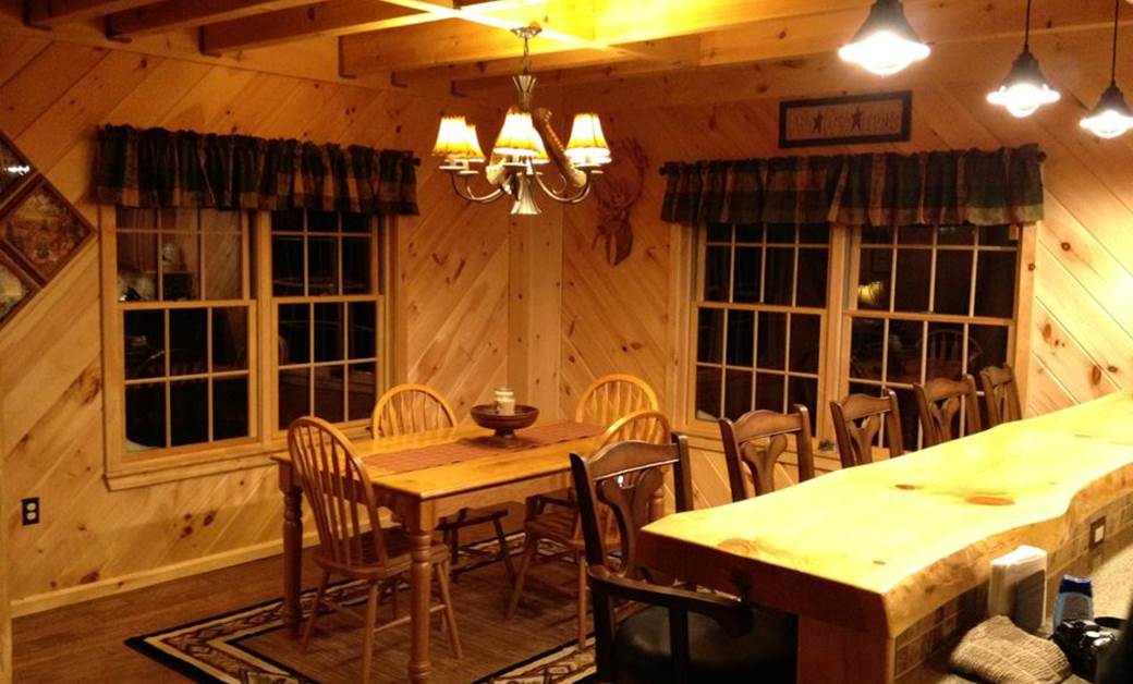 a warm log cabin with live edge accents and cabin kitchen cabinets
