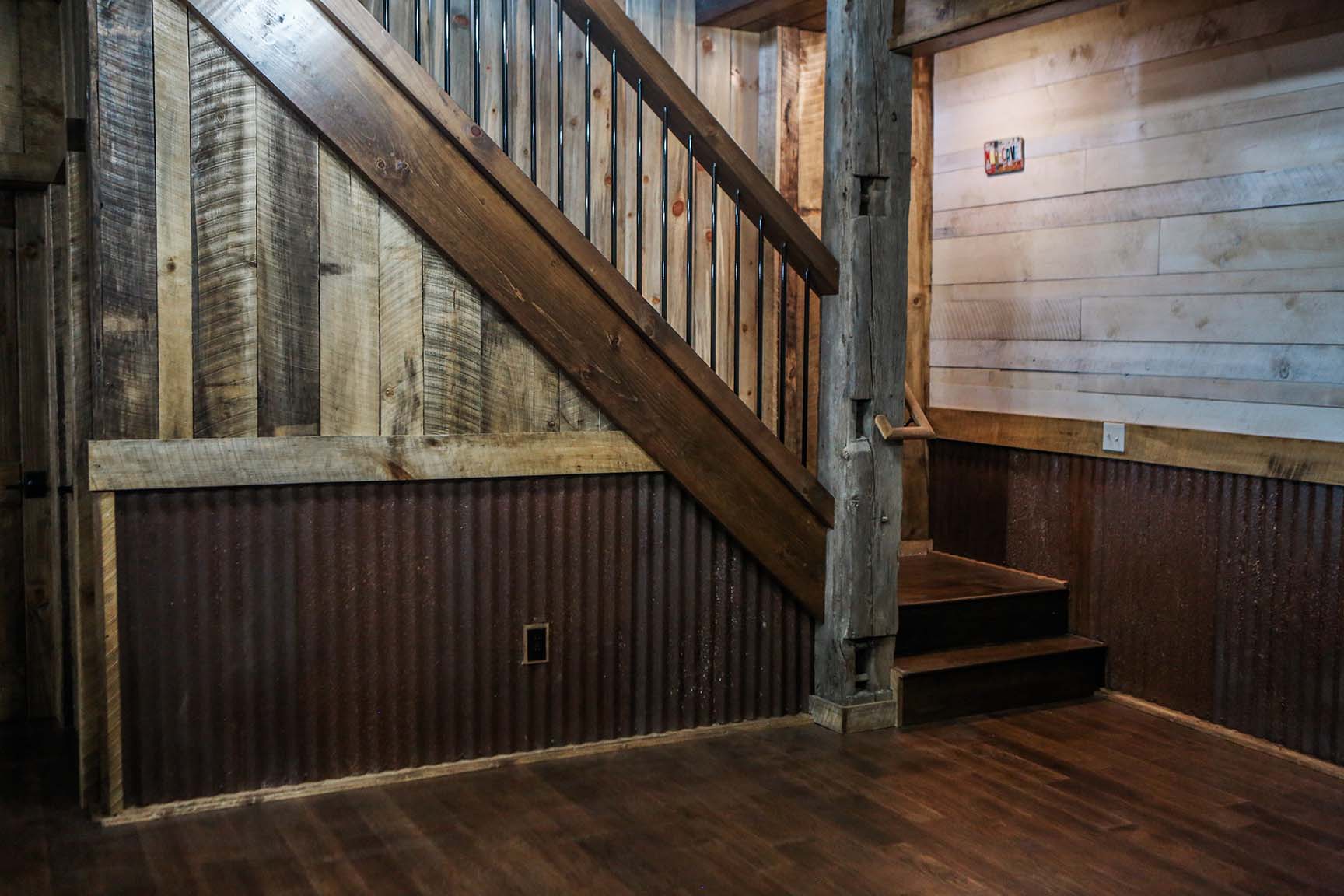 Black bar railing on an L-shaped staircase.