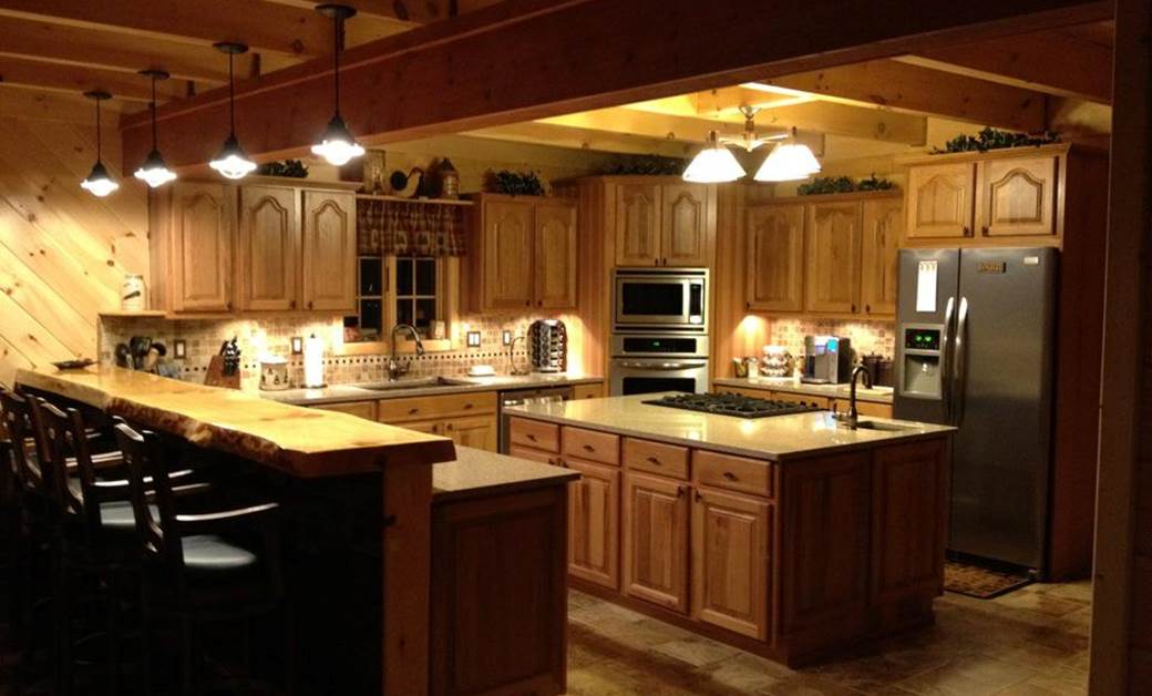 a rustic kitchen with wood accents and cabin kitchen cabinets