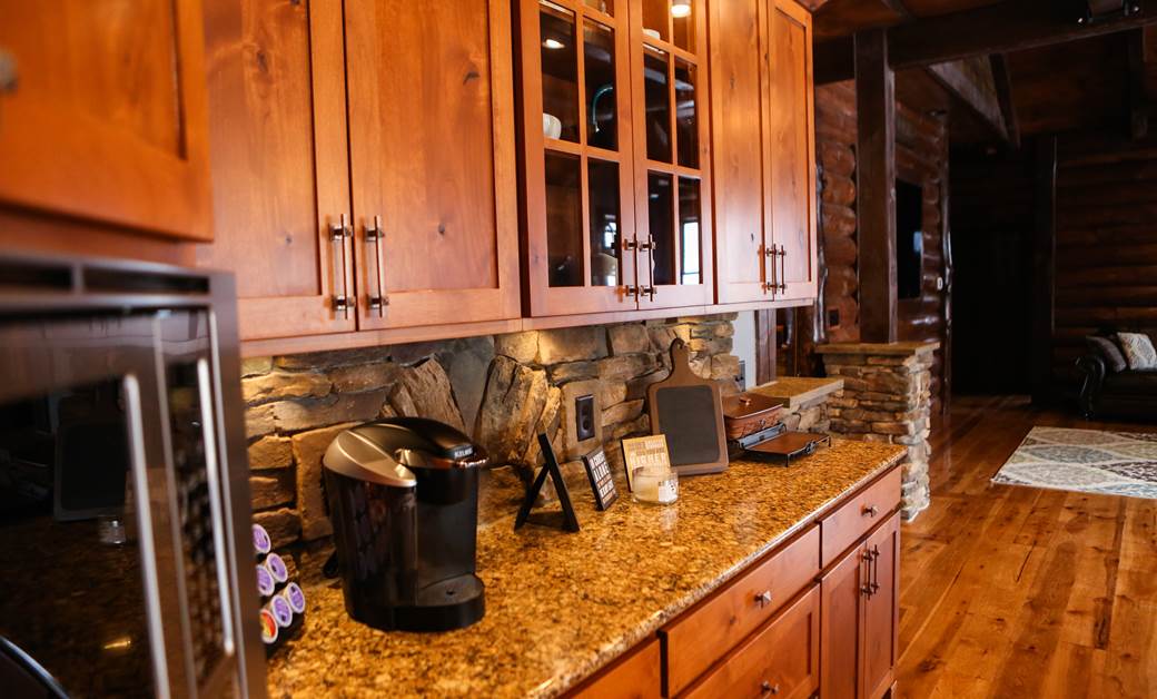 traditional wood cabinetry in a log cabin kitchen