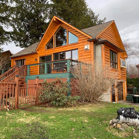 Exterior of timber frame home with 3x10 pine siding with cedar storm stain.