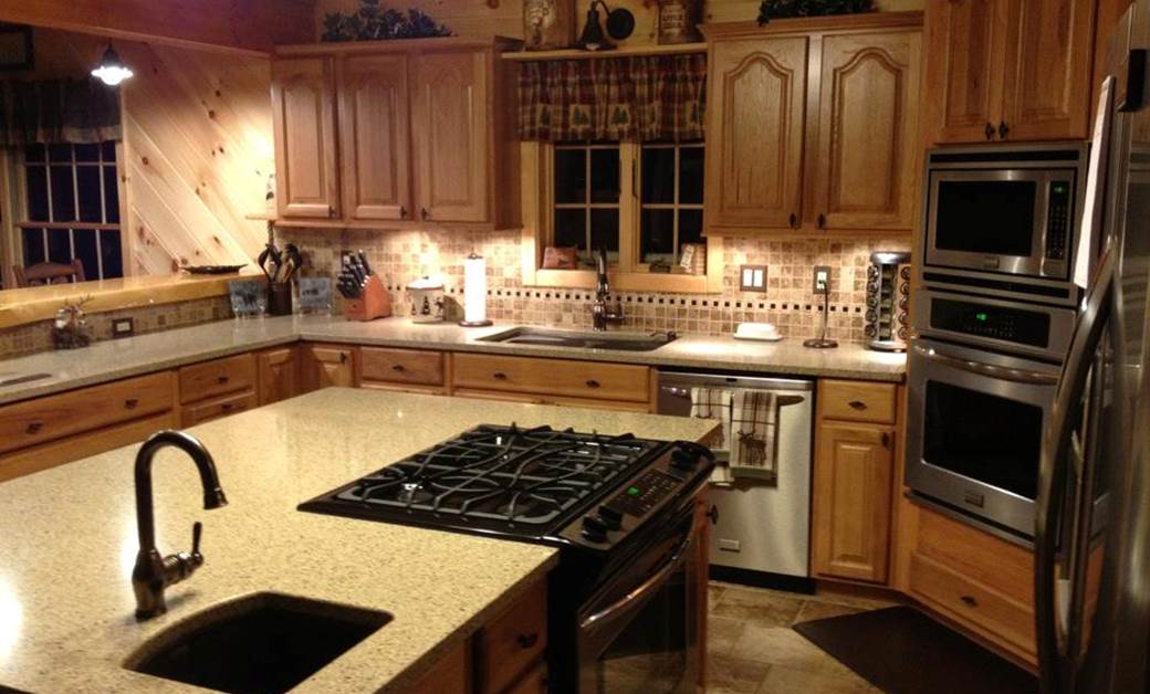 a log cabin kitchen with modern wood paneling