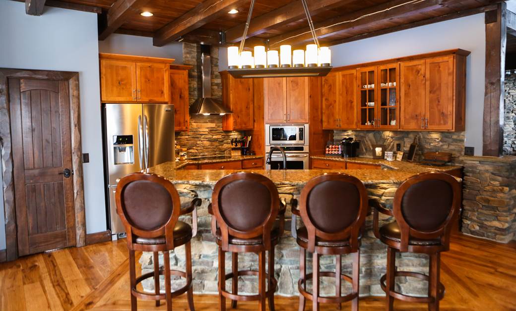 a modern kitchen island with stone accents