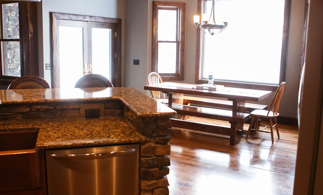 a large open concept kitchen with wood floors