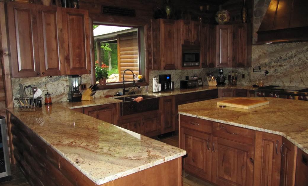 a log cabin kitchen with dark stain cabinets