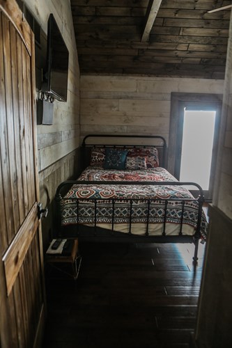 Rough sawn shiplap with whitewash in bedroom.