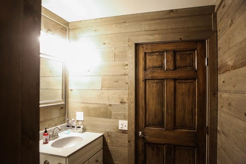 8” shiplap walls in weathered grey with bathroom sink and vanity.