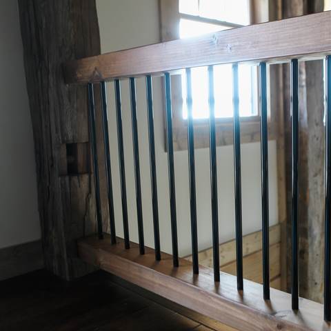 Close up of black bar railing.