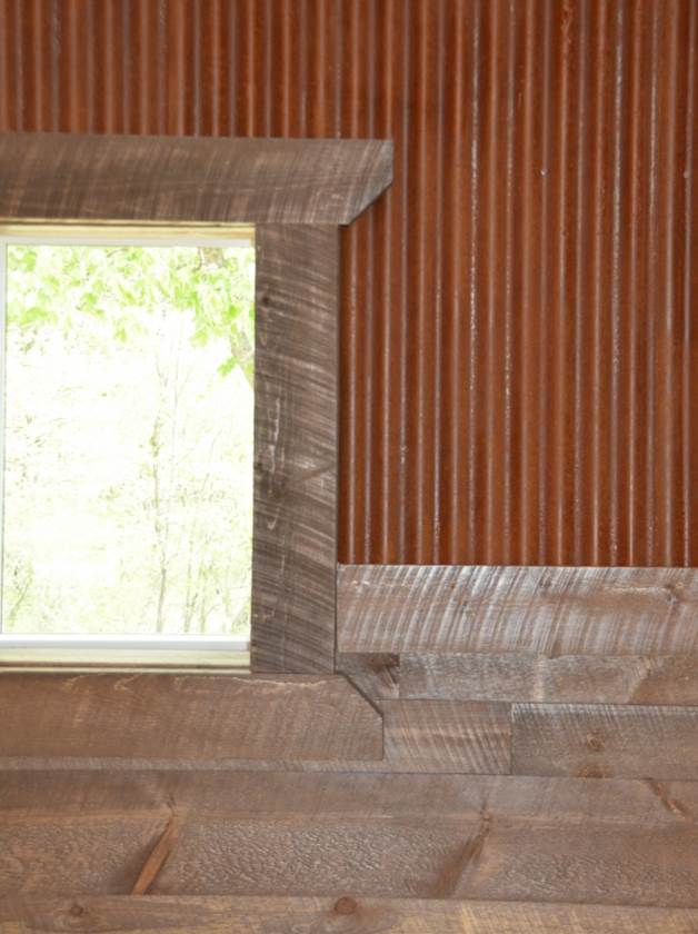 Circle sawn wood interior paneling with rusted metal above from Northern Log Supply